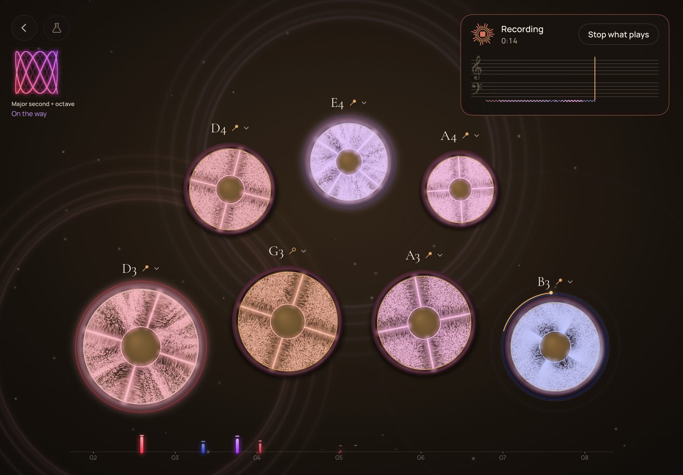 Eight bowls on a dark ground, each one's sand drawing its figure, while what is played is recorded.